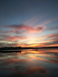 Scenic view of lake against romantic sky at sunset