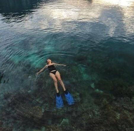 water, lifestyles, leisure activity, lake, full length, standing, young adult, reflection, casual clothing, rippled, vacations, three quarter length, high angle view, waterfront, nature, outdoors, person, young women