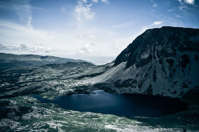 Scenic view of lake against sky during winter