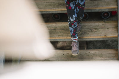 Low section of person standing in water