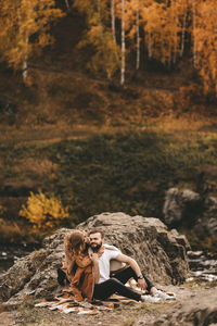 Woman sitting on rock