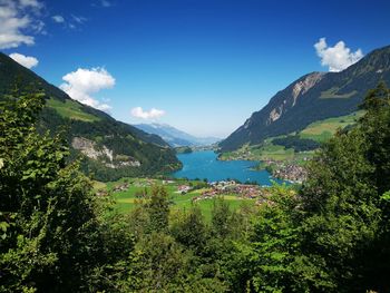 Scenic view of mountains against sky, with lake in the center of pic. 