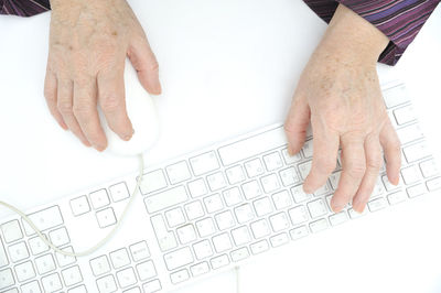 Cropped image of person typing on computer keyboard