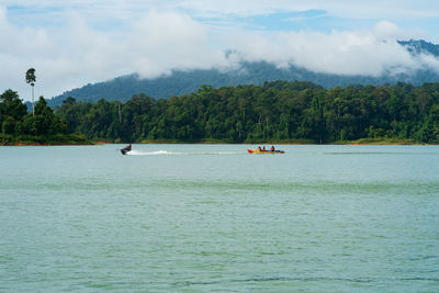 People sitting on boat in sea