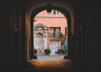 Archway leading towards building in city