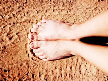 Low section of child on sand