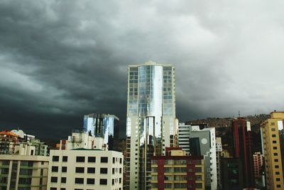 Low angle view of buildings against cloudy sky