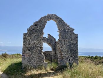 Old ruin on field against clear sky