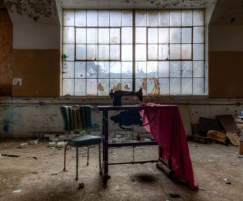 Chair and table in abandoned room