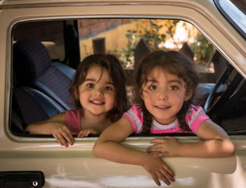 Portrait of smiling girl sitting in car