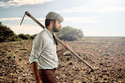 Full length of man standing on field against sky