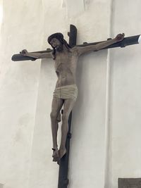 Low angle view of statue against wall