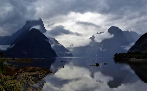 Scenic view of lake and mountains against sky