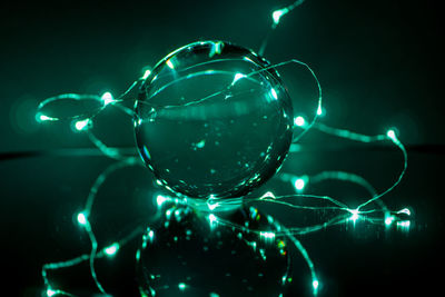 Close-up of illuminated glass on table