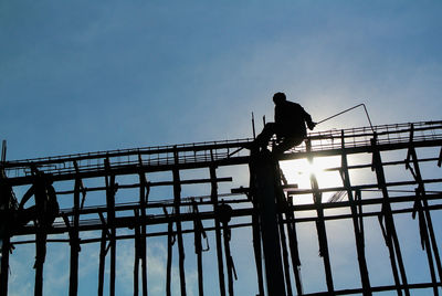 Laborer working on iron structure.