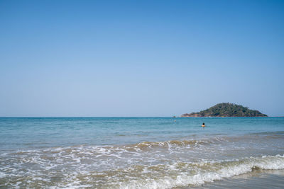 Scenic view of sea against clear blue sky