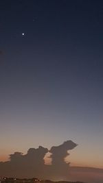 Scenic view of silhouette mountains against clear sky at night