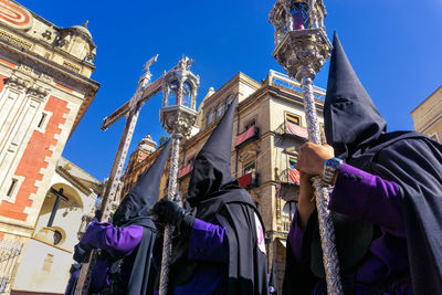 Low angle view of statues on building against sky