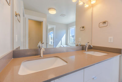 Interior of illuminated bathroom at home