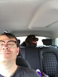 Portrait of happy man sitting in car