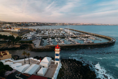 Aerial view of santa marta lighthouse in cascais, portugal with cascais marina and bay in background
