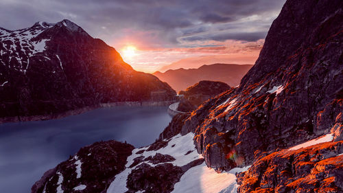 Scenic view of snowcapped mountains against sky during sunset