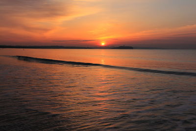 Scenic view of sea against orange sky