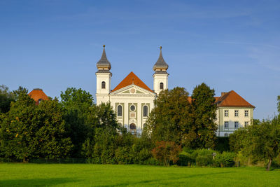 View of trees and building against sky