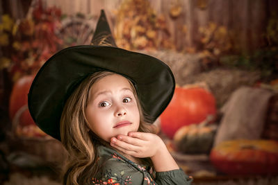 Portrait of a beautiful girl in a witch hat. going to the halloween party. 