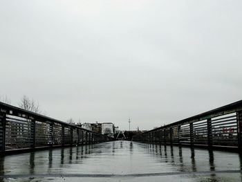 Empty walkway leading towards sea