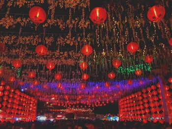 Low angle view of illuminated lanterns hanging at night