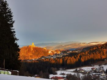 Scenic view of snow covered mountains against sky during sunrise