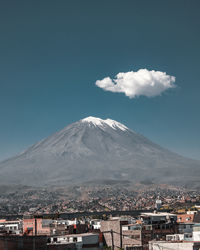 Aerial view of city against mountain and sky