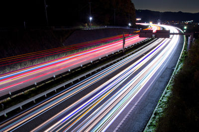 High angle view of light trails on road at night