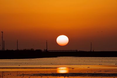 Scenic view of sea against sky at sunset