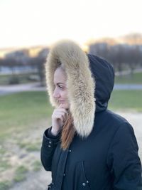 Portrait of woman wearing hat standing during winter