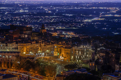 Aerial view of illuminated cityscape at night