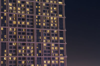 Low angle view of illuminated building against sky at night