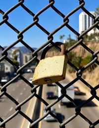 Close-up of padlock on chainlink fence