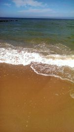 Close-up of waves on beach against sky