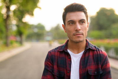 Portrait of young man standing outdoors