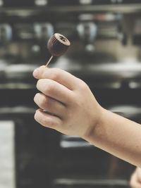 Cropped hand of child holding chocolate