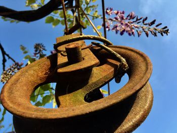 Low angle view of rusty metal against sky