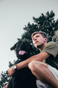 Man with dog against sky