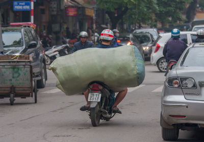 Rear view of people on street in city