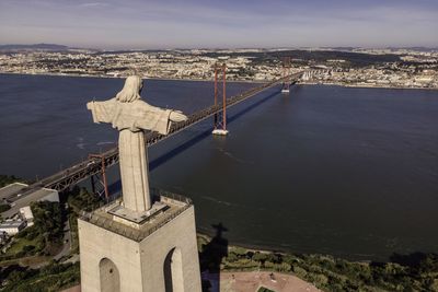 Bridge over sea against buildings in city