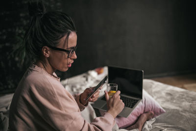 Midsection of woman using mobile phone