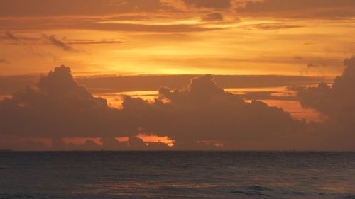 Scenic view of sea against orange sky