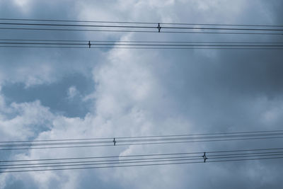 Low angle view of electricity pylon against sky