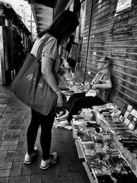 Full length of woman in front of city